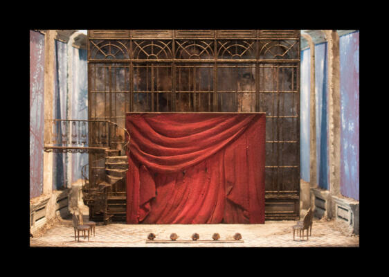 set design with red hanging curtain