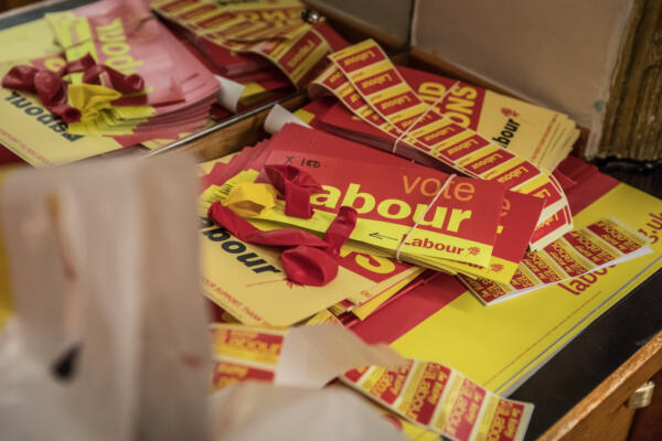 stack of vote labour stickers and posters