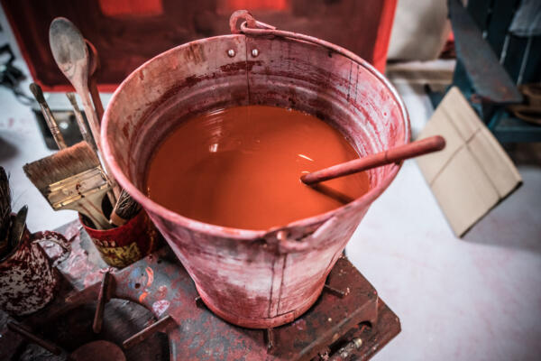 bucket of reddy-orange paint