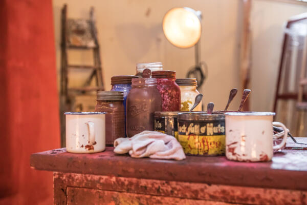 collected jars and tins of red paint