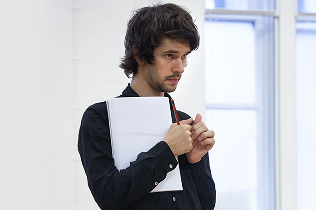 actor holding a script during theatre rehearsals