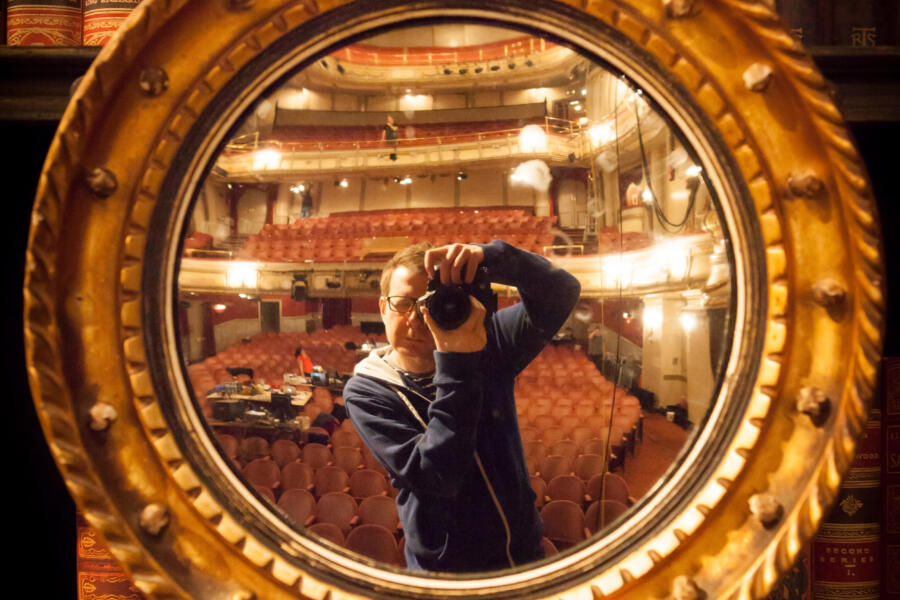 photographer photographing himself in an ornate mirror