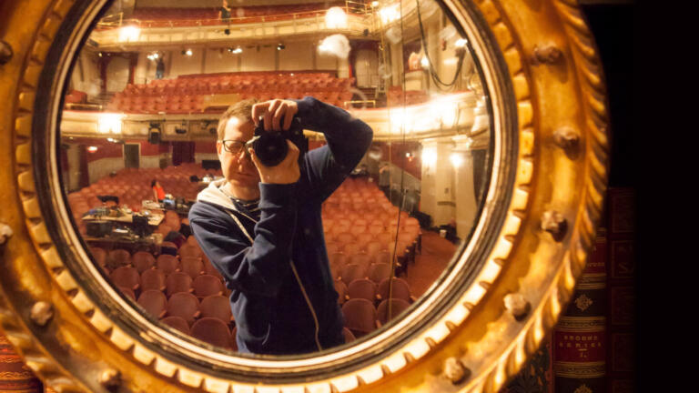 photographer photographing himself in an ornate mirror