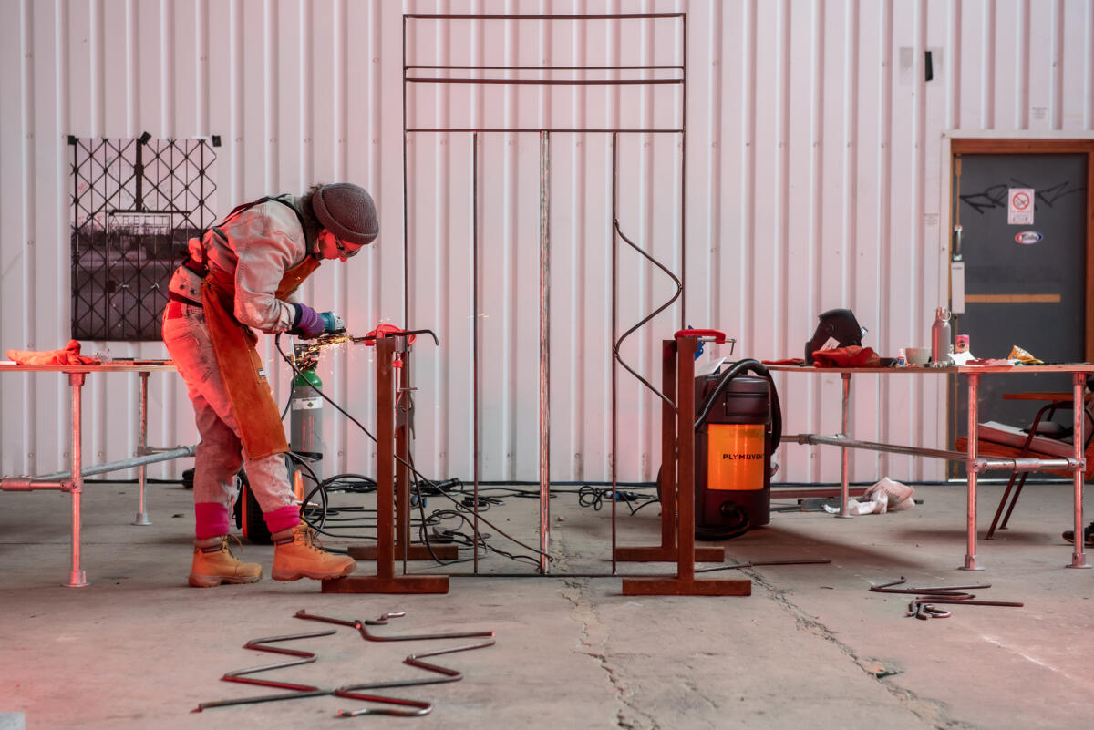 figure welding in a factory setting