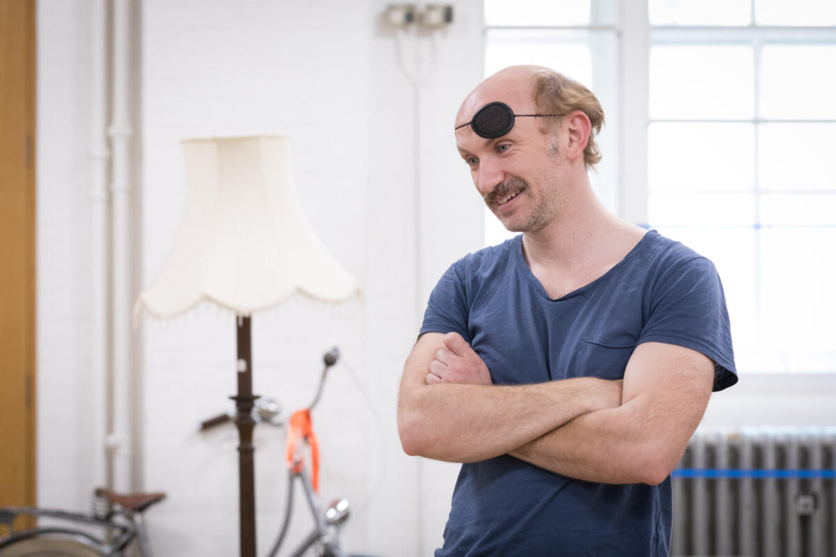 man in eye patch during theatre rehearsals